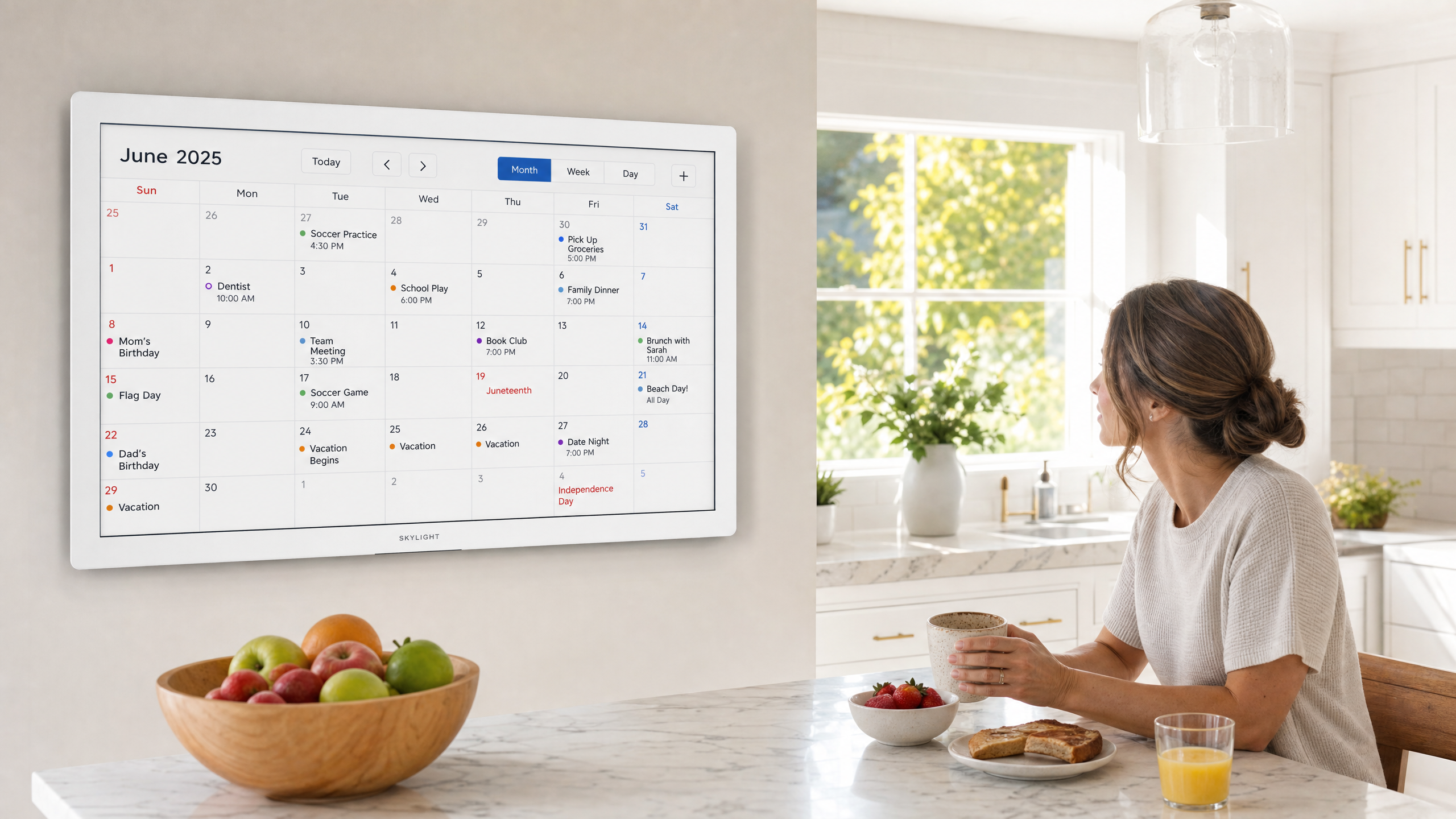 Digital calendar display mounted on kitchen wall showing family schedule