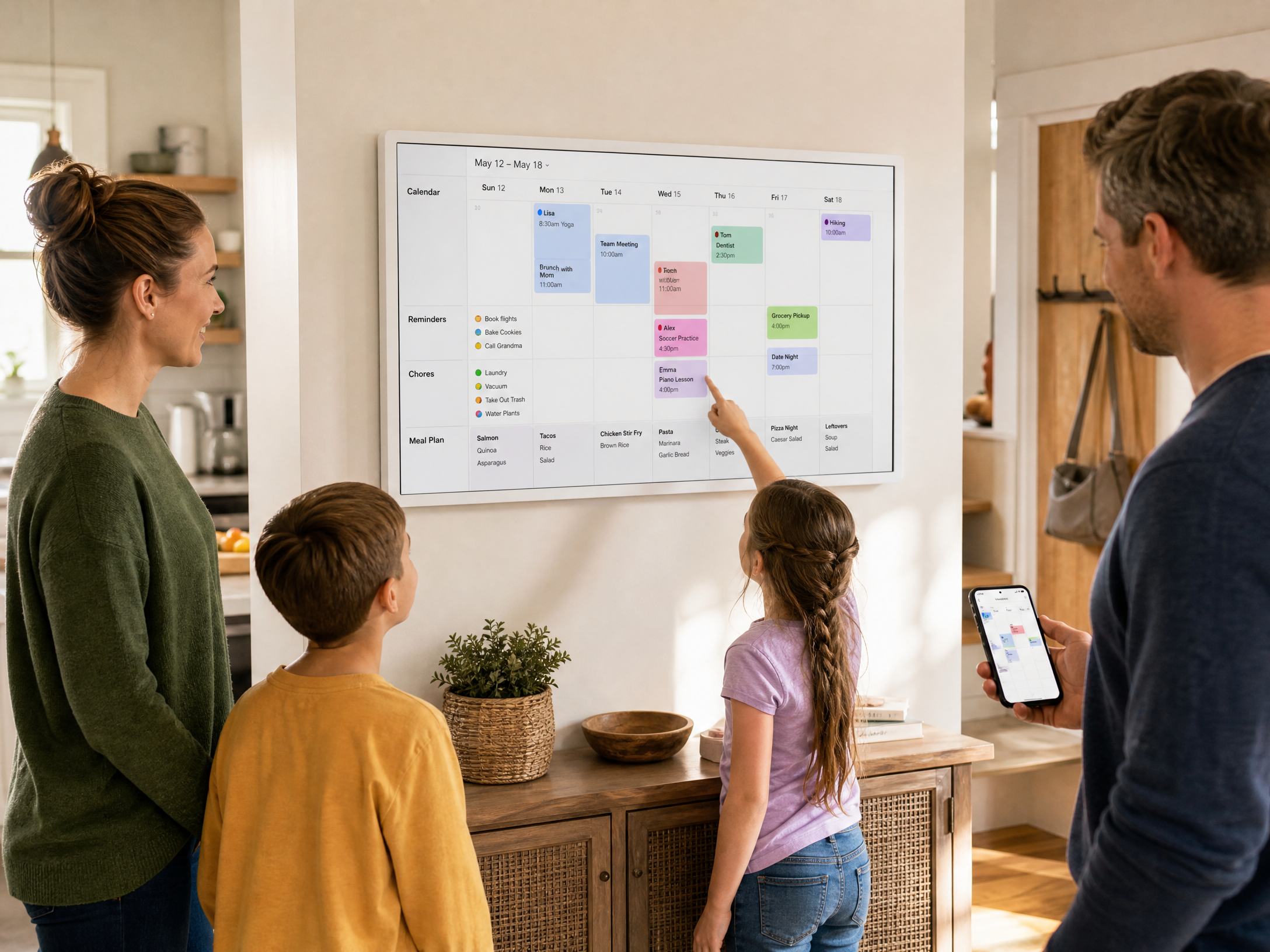 Family using a white touchscreen electronic calendar for shared schedules and reminders